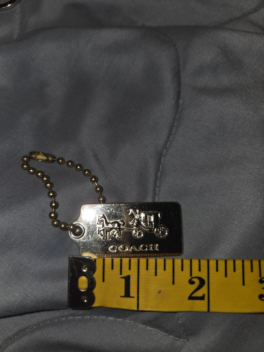 Coach Metal Dog Tag Keychain in Brass